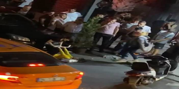 Kızını sokak ortasında sopayla döven anne